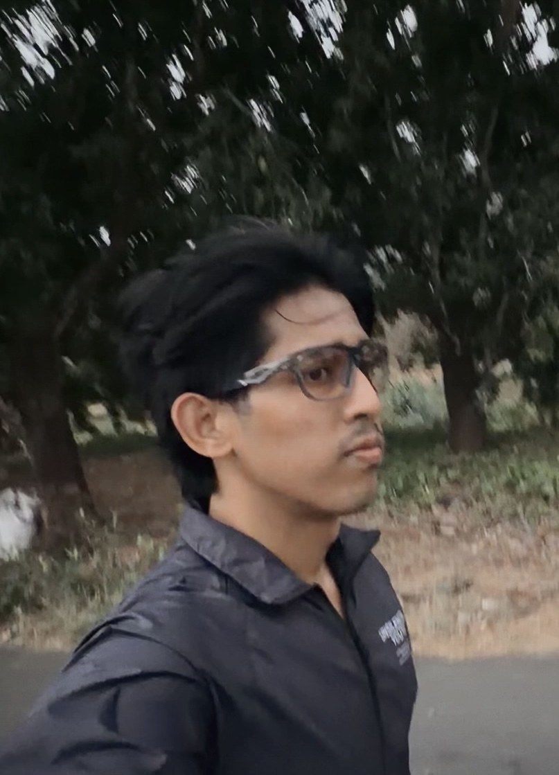 Faris outdoors wearing glasses